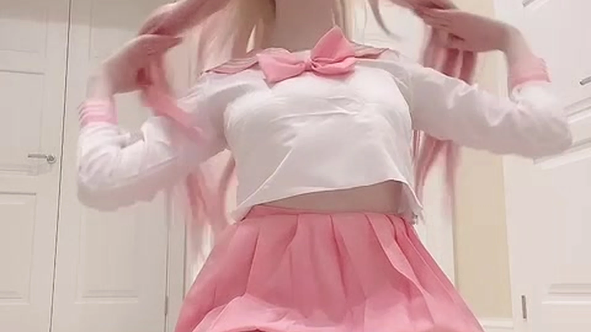 Alina Becker teasing in her pink schoolgirl cosplay