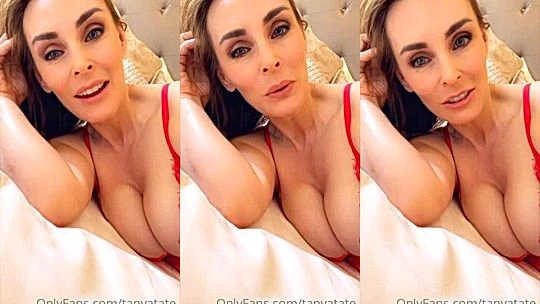 Tanya Tate teasing her huge breasts in bed