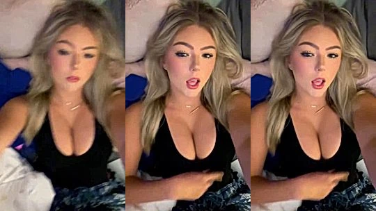 blonde bimbo Hailey Sigmond teasing her big boobies lying in bed