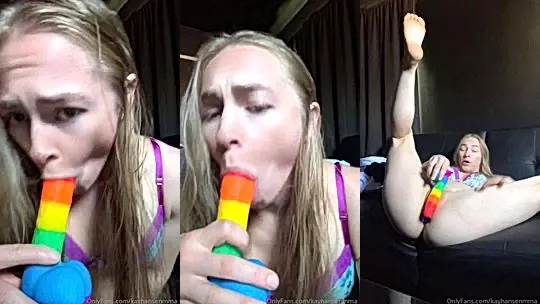 Kay Hansen playing with a rainbow dildo