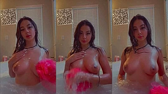 Asian.candy massaging her wet tits in the bathtub